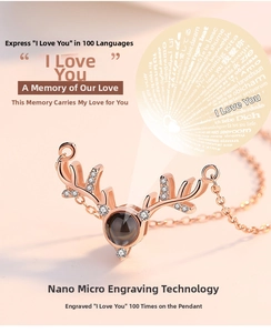 Macro detail of rose gold deer antler necklace with 100 languages I love you nano carving