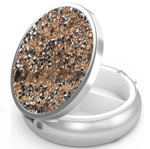 Detail view of round metal pill case with sparkly rhinestones and double compartments