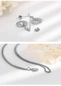 Detailed view of silver hollow heart and girl pendant necklace and earring set