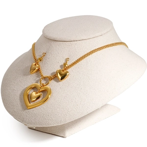 Fashionable golden hollow heart necklace and earrings set on a display stand
