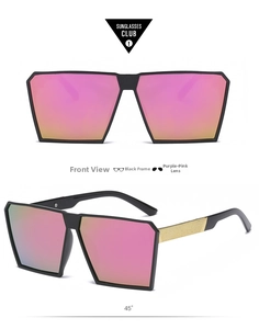 Detail of oversized square sunglasses with matte black frames and pink-gold gradient lenses