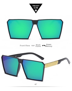 Detail of oversized black square sunglasses with green mirror lenses and gold temple texture