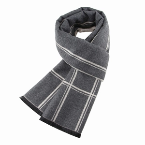 Detailed view of grey striped winter scarf for men with soft brushed texture and black tassels