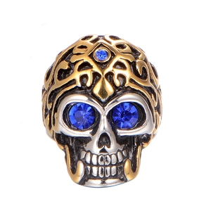 Vintage gothic skull ring with blue gemstones and gold-silver bicolor steel finish