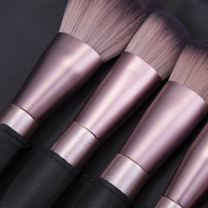 12pcs purple makeup brush set with metallic handles and gradient bristles in a black bag