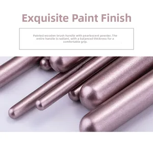 Close-up of rose gold pearlescent makeup brush handle made of lacquered solid wood
