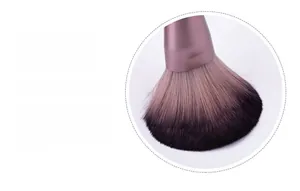 Detail of microcrystalline fiber bristles and purple metallic handle of the makeup brush
