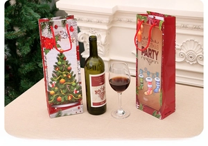Close-up of Christmas kraft paper wine gift bags with festive tree and party designs