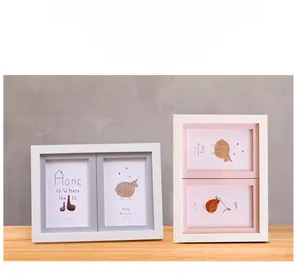 Close-up of white wooden double photo frame showing vertical and horizontal layouts