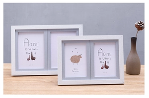 Close-up of dual white wood grain picture frames with Nordic minimalist style decor