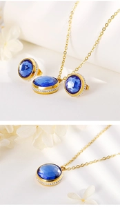 Detail of gold jewelry set with round blue gemstones and sparkling zircon accents