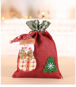 Detail of Christmas burlap gift bag featuring a 3D snowman and festive glitter tree