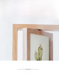 Detail of Nordic wooden rotating double-sided photo frame with a 360-degree swivel mechanism