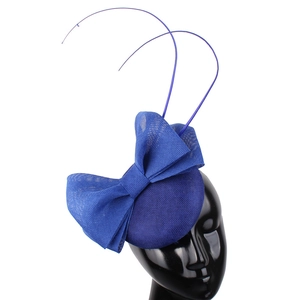 Detail view of the elegant blue mesh hat with a large bow and decorative feathers