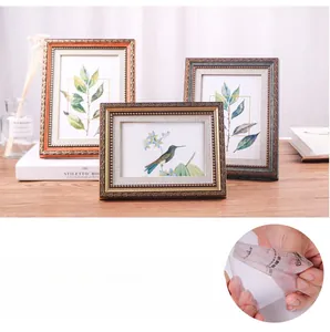 Detail of luxury European style photo frame with embossed gold trim and plexiglass panel