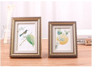 Close-up of European retro gold photo frames with intricate floral relief and bead details
