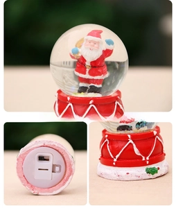 Detail view of the battery compartment and switch on the Christmas snow globe base