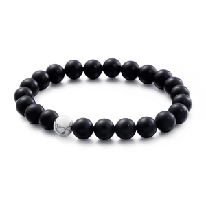 Handmade beaded bracelet with matte black onyx stones and a white marble turquoise bead