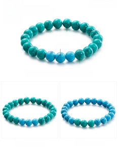 Detail of 8mm turquoise beaded bracelet showing green and blue stone texture and elastic cord