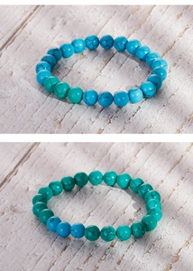 Macro view of blue and green turquoise beaded bracelets with natural black mineral veins