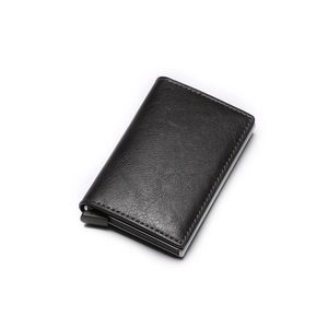 Detail view of black leather RFID-blocking card holder with smooth pop-up slide mechanism