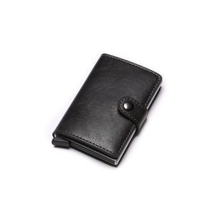 Detail of black leather automatic pop-up wallet with metal slot and snap closure