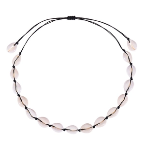 Detail of bohemian shell necklace with natural white cowrie shells and adjustable black cord