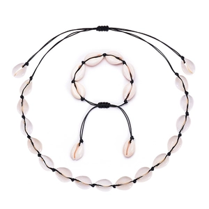Detailed view of handmade cowrie shell necklace and bracelet set with black braided cords