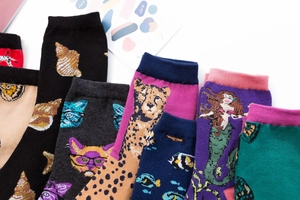 Flat lay view of colorful cotton crew socks featuring seashell and cat patterns