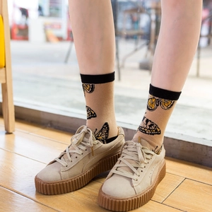 Mid-tube cotton crew socks featuring yellow butterfly print and black ribbed cuffs