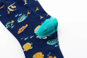 Macro shot of knitted cotton crew socks showing blue fabric and turquoise heel detail