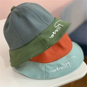 Detail of cotton fisherman hats in green, red, and blue with Pioneer embroidery