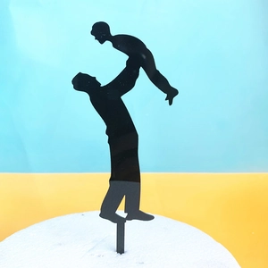 Black silhouette cake topper showing a father lifting child for birthday decoration