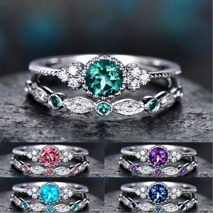 Detail view of two-piece ring set with round emerald cut stone and marquise accents