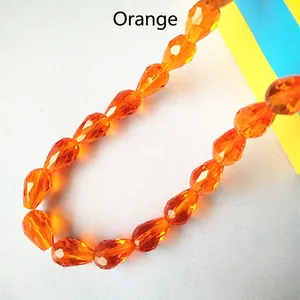Detail shot of orange red faceted crystal teardrop beads for DIY jewelry making and crafts