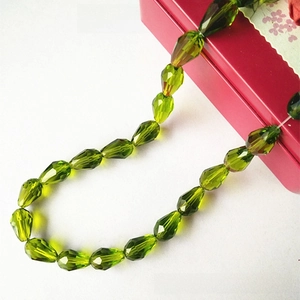Close-up of olive green faceted water drop glass beads for DIY jewelry making accessories