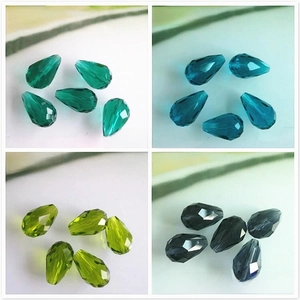 Macro view of faceted teardrop crystal beads in peacock green and olive green