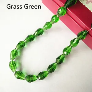 Macro shot of grass green faceted glass water drop beads for DIY jewelry making and decor