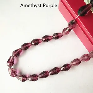 Macro shot of faceted medium purple teardrop crystal beads for DIY jewelry making