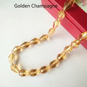Close-up of faceted teardrop glass beads in gold champagne for DIY jewelry making