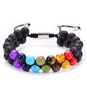 Detailed macro view of seven chakra double-row natural lava stone braided bracelet
