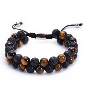 Detail of woven double-layer bracelet with tiger eye beads and porous black lava stones