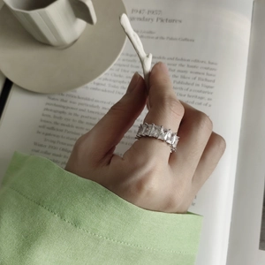 Detail of 925 silver ring with rectangular clear gemstone on a stylish background