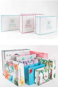 Detail view of various printed kraft paper gift bags with sturdy woven rope handles