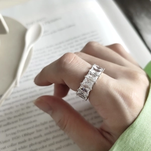 Elegant 925 sterling silver ring with rectangular baguette cubic zirconia on book background