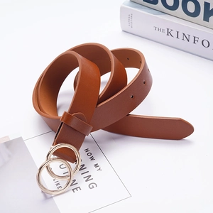 Macro shot of a thin brown leather belt with a golden double ring buckle on white background