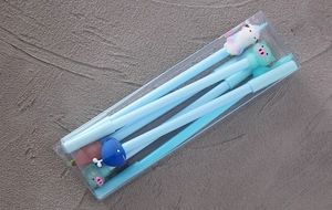 Close-up of cute cartoon gel pen set featuring animal caps in a transparent plastic box