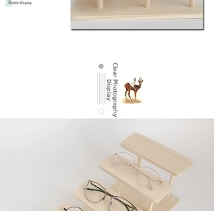 Close-up of a three-tier solid wood eyewear display stand with clear glasses on it