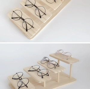 Detail view of tiered wooden display stand for organizing multiple pairs of sunglasses