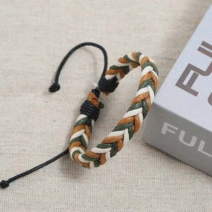Detail of adjustable handmade woven bracelet in brown, dark green, and cream fiber